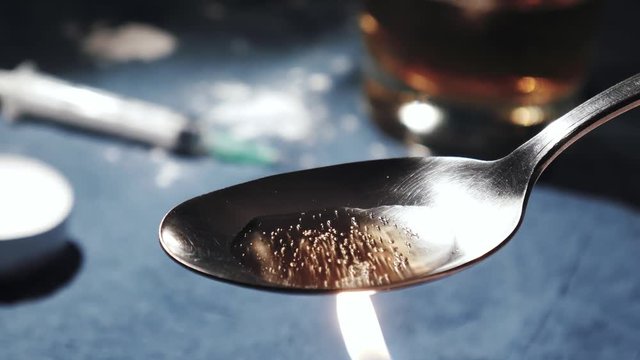 Cooking Heroin on a spoon
