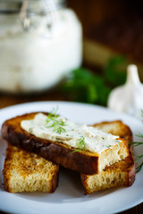 Sandwich of fried toasts with garlic melted cheese