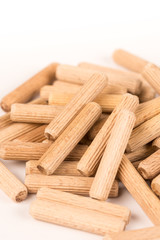 Pile of wooden dowels isolated on white background