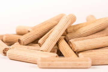 Pile of wooden dowels isolated on white background