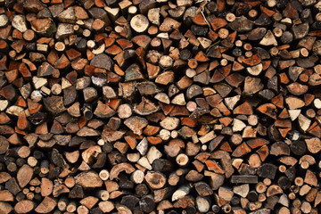 Pile of Firewood Dry Chopped Logs Wall Stack for Winter Texture Pattern Background 