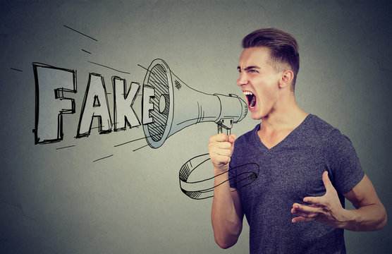 Angry enthusiastic man screaming in a megaphone spreading fake news 