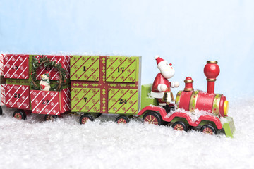 Santa Claus riding on train threw snow carriing days until christmas