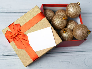 gift box with balls and a piece of paper with space for lettering