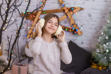 Beautiful girl listening to the music in headphones