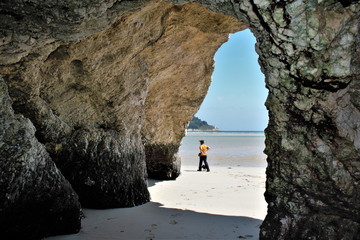 Caves marine, grotto marine in white quartz mountain during low tide in the estuary of Sor river in...