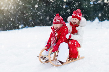 Kids on sleigh. Children sled. Winter snow fun.