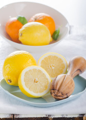 Fresh lemons cut in half on blue plates