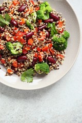 Quinoa salad with broccoli, red beans, paprika and greenery. Super food and healthy eating concept. Overhead view. Copy space 