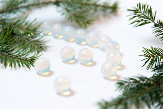 macro shooting of natural mineral rock specimen - tumbled translucent moonstone gemstone on white background christmas tree