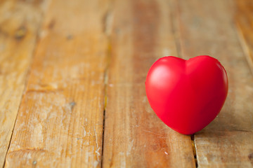Fototapeta premium Red mini heart on wooden plate with copy space