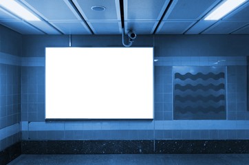blank advertising billboard or light box showcase at airport or subway train station, blue color tone, copy space for your text message or media content, commercial and marketing concept