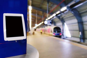 blank screen digital monitor or tablet on counter at subway train station, copy space for text or media content, ticket vending machine, commercial, marketing and advertisement concept