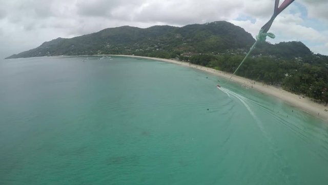 An adventurous couple parasailing at Beau Vallon Beach in Mah_, Seychelles. GoPro, extreme summer sports, POV.  onboard camera. , 2 of 3