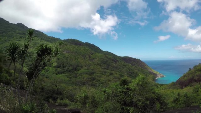 Go Pro view from Silhouette island, Seychelles onto Anse Mondon beach below the giant granitic rock boulders (granite island) from above the forest/jungle. POV. 