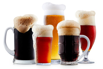 Mug collection of frosty dark red and light beer with foam isolated on a white background
