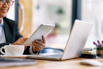 Business woman working on business office desk with laptop, report papers and Office table.