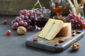 Blue cheese with grapes, nuts and honey. Appetizers table concept for mediterranean lunch oder dinner.Antipasti