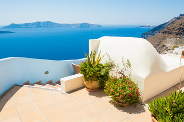 Naklejka na ściany i meble Santorini island, Greece. Beautiful terrace with flowers, sea view.