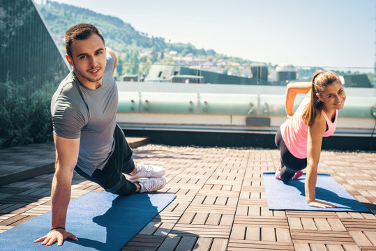 Couple Doing Side Plank Exercise.