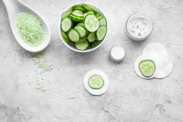 Natural cucumber cosmetics. Lotion, cream, spa salt on white background top view copyspace
