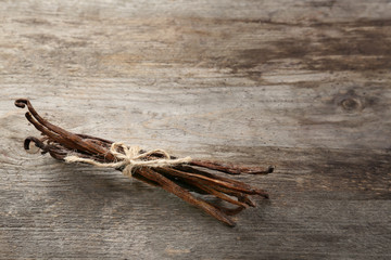Dried vanilla pods on wooden background