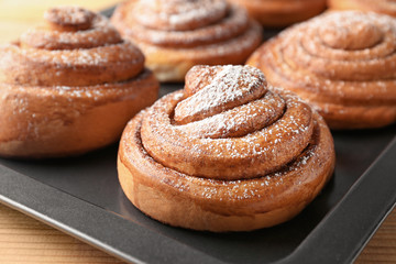 Baking tray with sweet cinnamon rolls, closeup