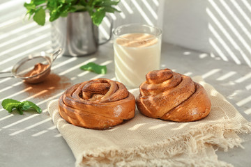 Sweet cinnamon rolls on table