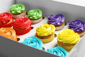 Tasty colorful cupcakes in box