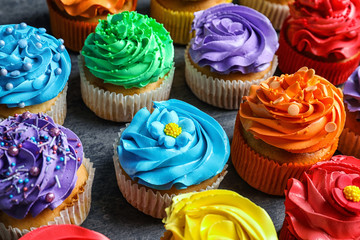 Tasty colorful cupcakes on table