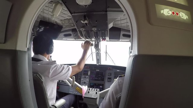 GoPro point of view into the cockpit of a small plane with two pilots at lift-off/take off from a tropical island. POV.  
