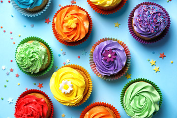 Tasty cupcakes on color background