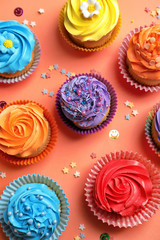 Tasty cupcakes on color background