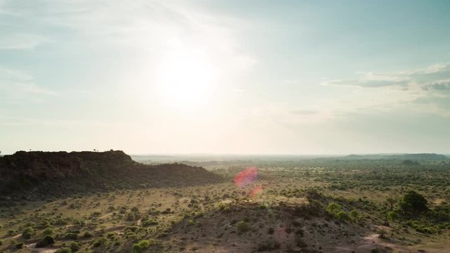 A slow panning timelapse in the Mashatu Game Reserve, Botswanan showing the wide open landscape as the sun set dips to black with moody clouds. 