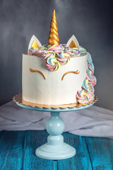 Beautiful bright cake decorated in the form of fantasy unicorn. Concept of a festive dessert for...