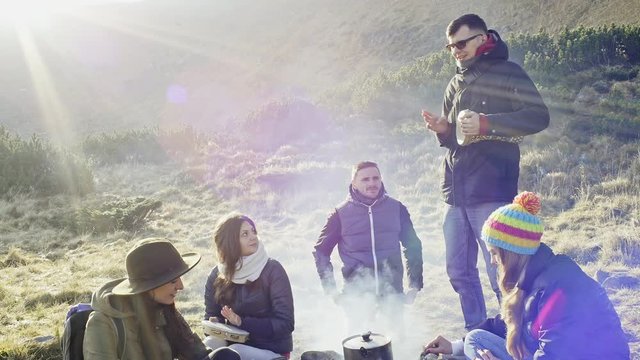 Group of friends enjoying at camping in mountains