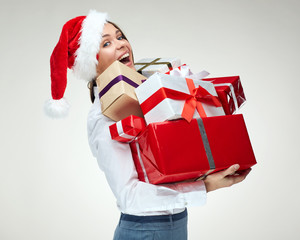 Young businesswoman holding pile of christmas gifts.