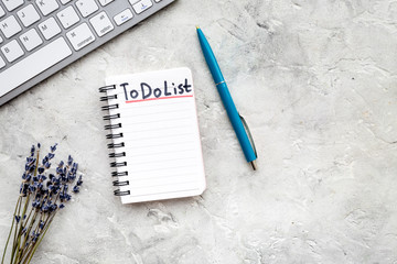 Planning day in the morning. Notebook with to do list near lavender flower branches and keyboard on...