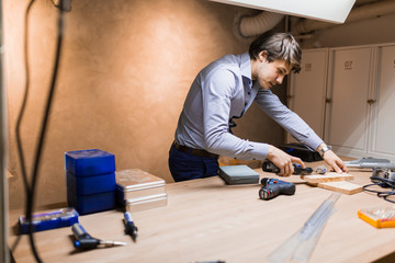 Joiner working and designing on workbench