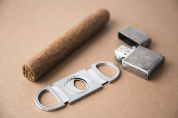 Cigar, Cigar Cutter and Metal Lighter on Dark Background Natural Light Selective Focus