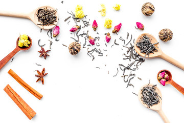 Dried tea leaves near supplements like flowers and spices on white background top view pattern copyspace