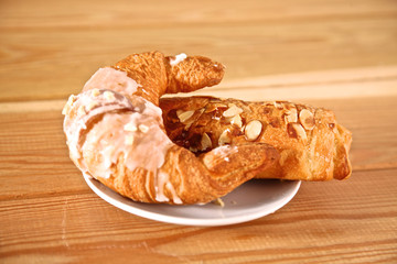 Croissant in the plate on the table