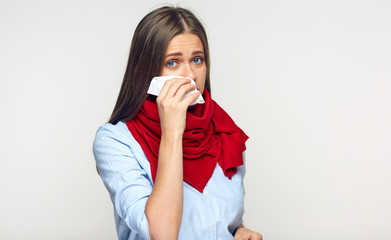 Sickness woman blowing his nose in paper tissue.