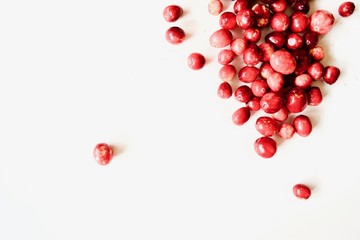 A lot of tasty and healthy red cranberries on the white background.