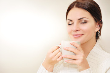 Beautiful woman drinking coffee or tea