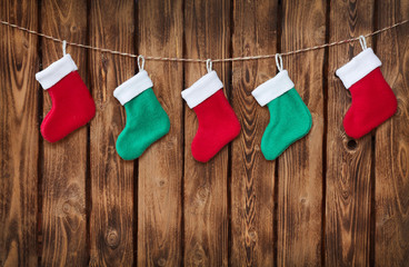 Christmas decorations and sock on wood background