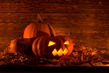 evil halloween pumpkin on wooden background, copy space