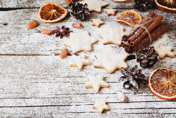 Christmas gingerbread cookies stars on a wooden table and cookie cutters, selective focus