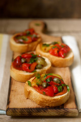 Fresh and tasty bruschetta with pickled bell pepper, capers and parsley.