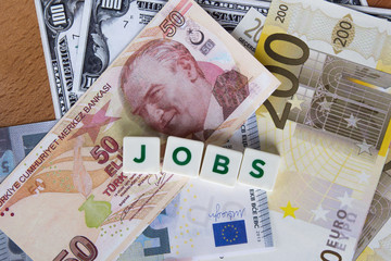 Jobs Word with Letters Among Banknotes